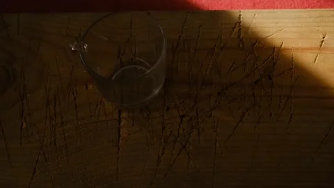 Empty pot and cup made of glass material existing on wooden plate Stock Footage 151054462