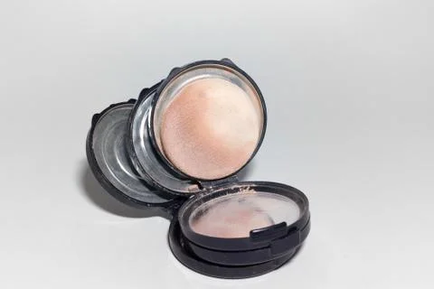 Empty powder boxes, lying on each other and one used sponge puff Stock Photos