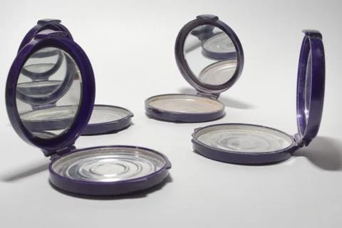 Empty powder case with mirror, that reflect each other Stock Photos