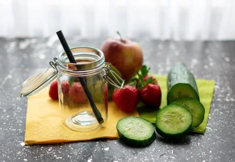 Empty preserving jar surrounded by fresh fruit Stock Photos