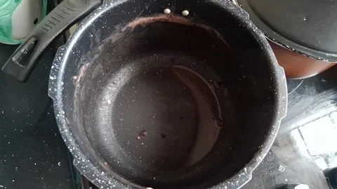Empty pressure cooker pot sitting on kitchen stovetop motion video footage Stock Footage 341524299