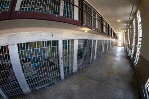 Empty Prison Corridor with Rows of Metal Jail Cells Foto stock