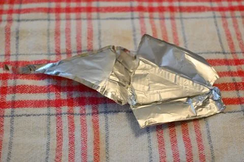 Empty processed cheese packaging on a checked cloth Stock Photos
