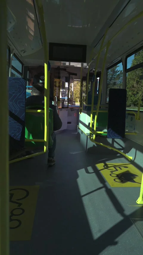 Empty public bus interior traveling through city streets Stock Footage 329510169