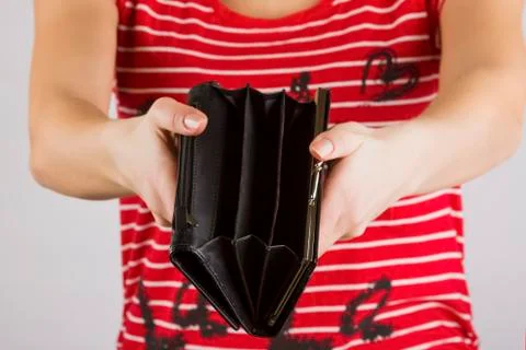 Empty purse in women's hands Stock Photos