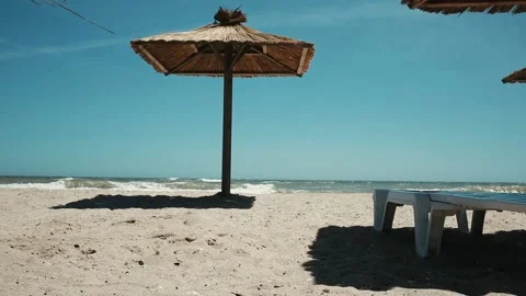 Empty quarantine beach with straw umbrellas Stock Footage 151899294