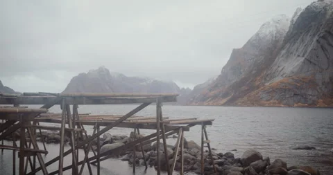 Empty racks to dry cod fish at Reine village, Lofoten, Norway on cloudy day Stock Footage 243586227