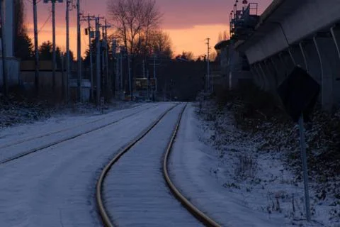 Empty rail in city while colorful sunset in winter Stock Photos