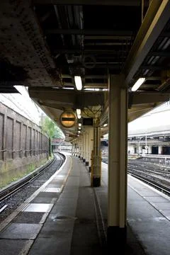 Empty railway platforms under a canopy at Victoria railway terminus in London Stock Photos