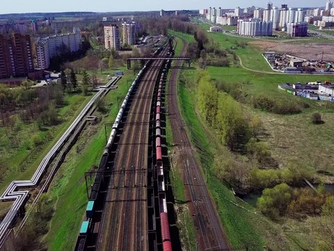 Empty railway in the spring. Freight train with cargo on the tracks. Stock Footage 75679396