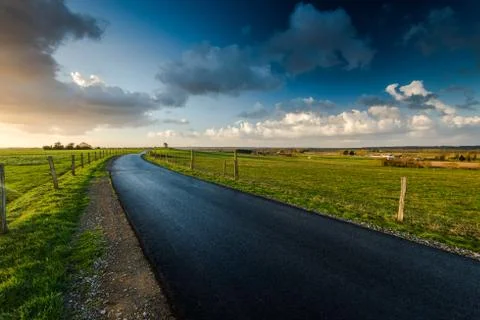 Empty raod in farm fields in Normandy,France Stock Photos