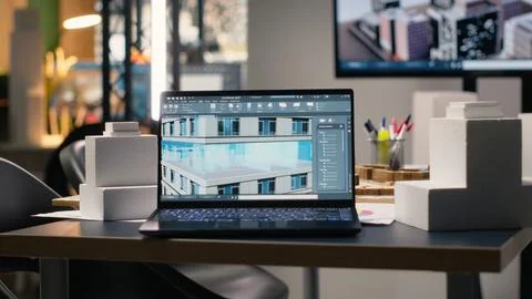 Empty real estate development office filled with blueprints and 3D models Stock Photos