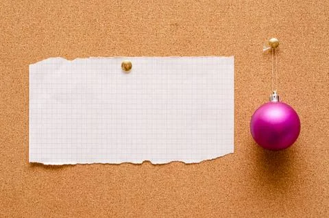 An empty record sheet and a Christmas tree toy are pinned on a cork board. .. Stock Photos