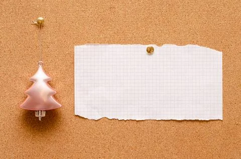 An empty record sheet and a Christmas tree toy are pinned on a cork board. .. Stock Photos