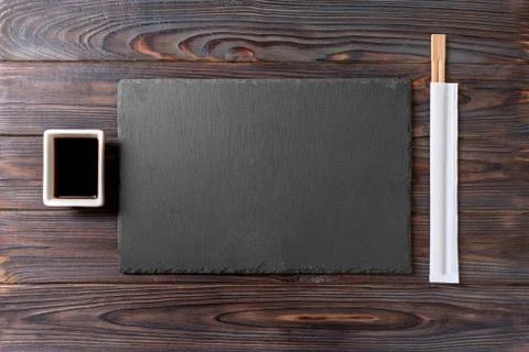 Empty rectangular black slate plate with chopsticks for sushi and soy sauce o 스톡 사진
