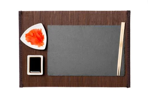 Empty rectangular black slate plate with chopsticks for sushi, ginger and soy 스톡 사진