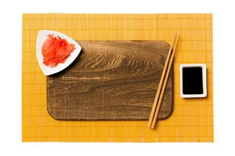Empty rectangular brown wooden plate with chopsticks for sushi, ginger and so 스톡 사진