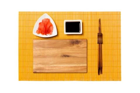 Empty rectangular brown wooden plate with chopsticks for sushi, ginger and so 스톡 사진