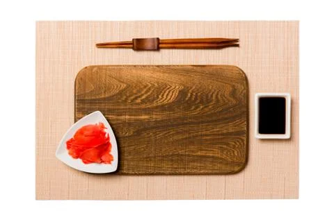 Empty rectangular brown wooden plate with chopsticks for sushi, ginger and so 스톡 사진