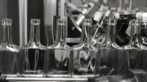 Empty rectangular glass bottles move along a conveyor belt. Stock Footage 284316434