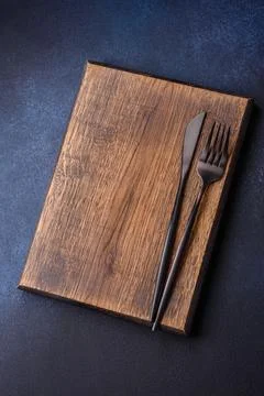 Empty rectangular wooden cutting board on dark concrete background Stock Photos