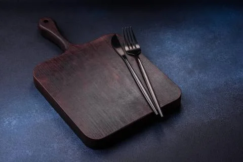 Empty rectangular wooden cutting board on dark concrete background Empty r... Stock Photos