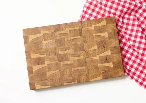 Empty rectangular wooden kitchen cutting board and red towel in a white cage  스톡 사진