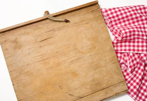 Empty rectangular wooden kitchen cutting board and red towel in a white ca... Stock Photos