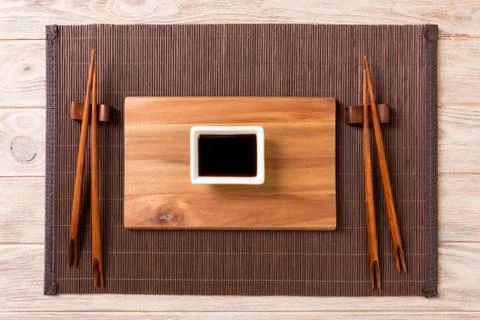 Empty rectangular wooden plate with chopsticks for sushi and soy sauce on woo Stock Photos