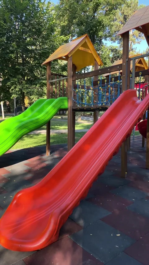 Empty red and green playground slide, outdoor play Stock Footage 342986552