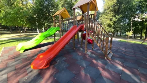 Empty red and green playground with slides and climbing equipment Stock Footage 342986557