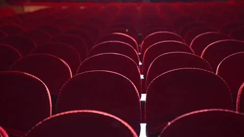 Empty red armchairs in theater. Rows of velvet chairs without people before  Video stock 147088026