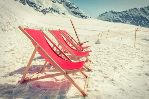 Empty red beds on the snow, relaxing concept Stock Photos