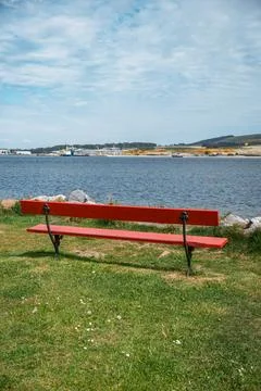 Empty red bench overlooking the sea Stock Photos
