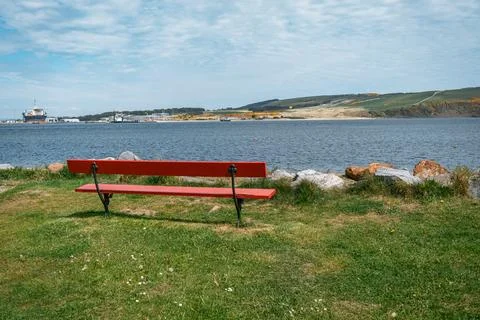 Empty red bench overlooking the sea Stock Photos