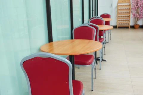 Empty of red chairs and round wooden tables Stock Photos