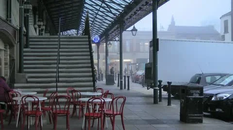 Empty red chairs and white tables outside cafe under canopy of market hall Stock Footage 15037220