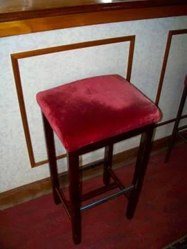 An Empty Red Cusioned Bar Stool Stock Photos