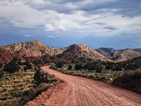 Empty red dirt road in the mountains. Arizona. Stock Photos