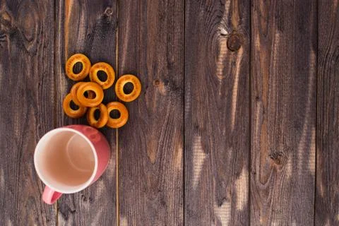 Empty red mug and bagels on a dark wooden table Stock Photos