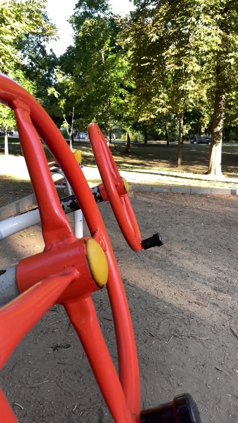 Empty red outdoor exercise equipment in a city park, fitness Stock Footage 342994292