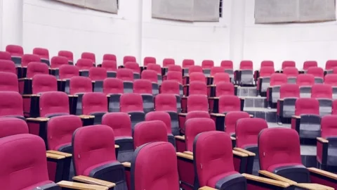 Empty Red Plastic Chairs Arranged in Rows Inside Hall Vidéo 329178469