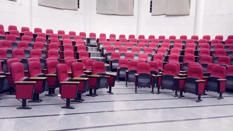Empty Red Plastic Chairs Arranged in Rows Inside Hall Video stock 329178480