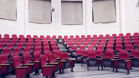 Empty Red Plastic Chairs Arranged in Rows Inside Hall Video stock 329178488