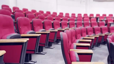 Empty Red Plastic Chairs Arranged in Rows Inside Hall Stockbeeldmateriaal 329178503