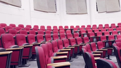 Empty Red Plastic Chairs Arranged in Rows Inside Hall Vidéo 329178515
