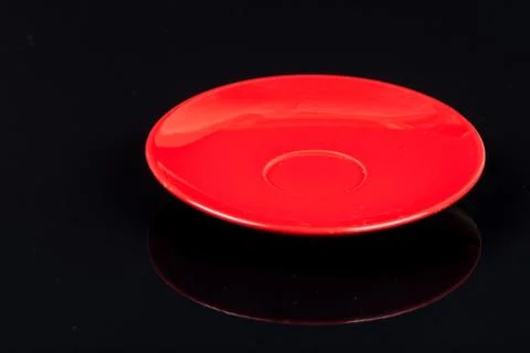 Empty red plate on the black background with reflections Stock Photos