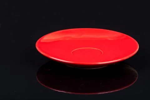 Empty red plate on the black background with reflections Stock-Fotos