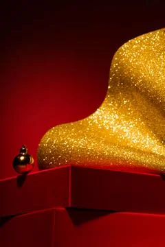 Empty Red podium with gift boxes, gold Christmas decor Red background. 스톡 사진
