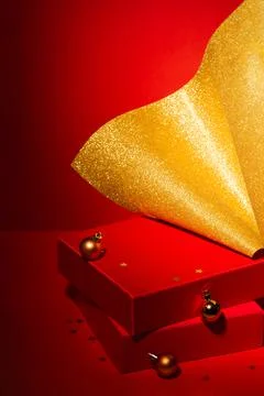 Empty Red podium with gift boxes, gold Christmas decor Red background. 스톡 사진